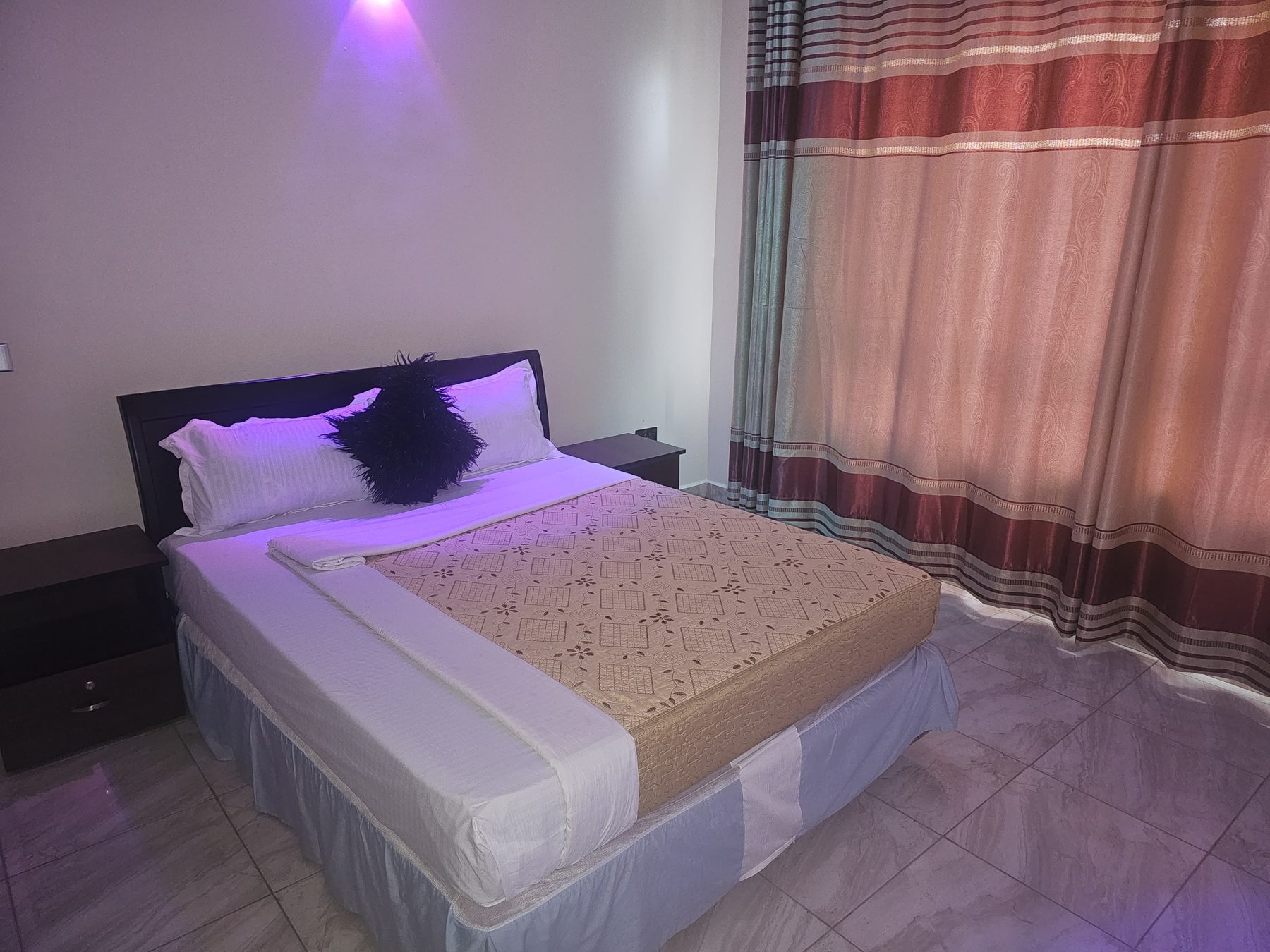 Deluxe bedroom suite at Denver Elysium with warm ambient lighting